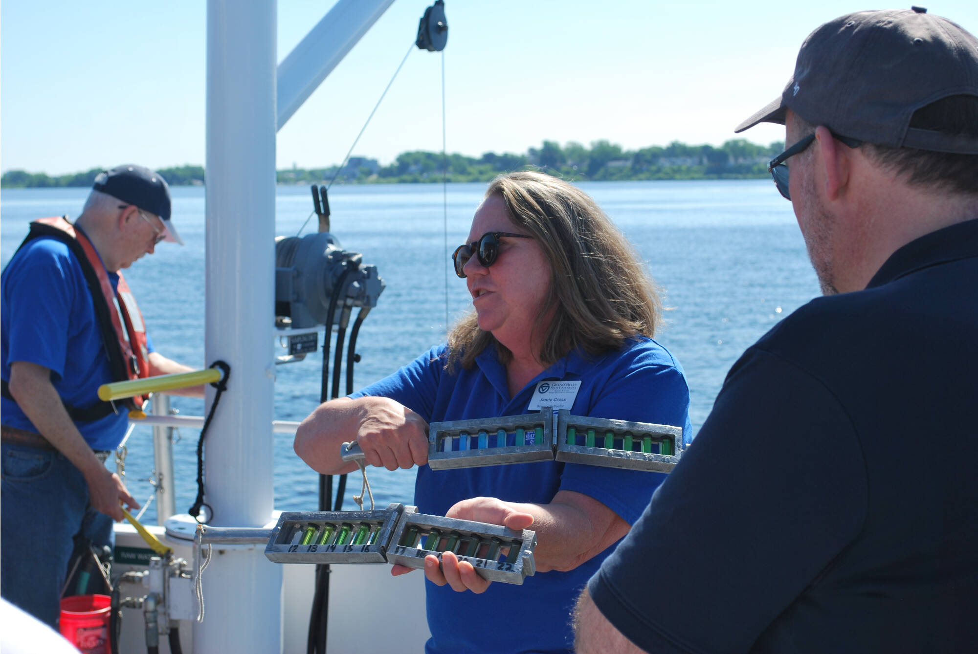 Jamie Cross displays a Florel-Ule scale, a series of colored water in vials that provides a measurement of water clarity not requiring expensive machines..